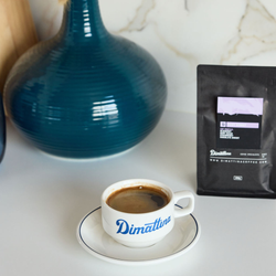 A cup of Dimattina coffee next to a bag of Easy Street