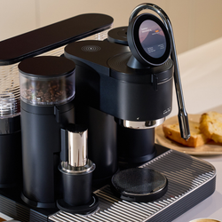 Meraki Gen 2 black coffee machine with a digital display screen, bean hopper, and milk frother. 
