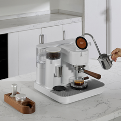 White Meraki Gen 2 on kitchen counter frothing milk with steam wand