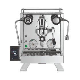 A silver Rocket Espresso Cinquantotto espresso machine with dual boilers, a touch screen communication pod, and a brass grouphead.