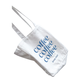 A white cotton tote bag with 'coffee coffee coffee' printed in blue text on the side, featuring two handles and a wine bottle pocket.