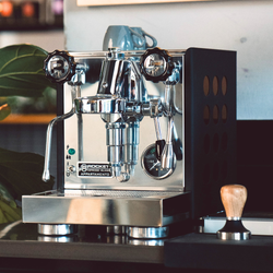Rocket Appartamento espresso machine on a counter with accessories