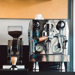 Rocket Giotto R espresso machine on a bench with espresso making accessories