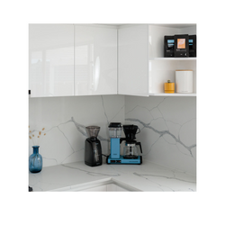 Baratza Encore in a kitchen with white cabinets and white marble countertops