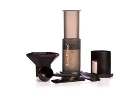 Aerobie Aeropress coffee maker with components, including a press, cup, and funnel, displayed on a white background.